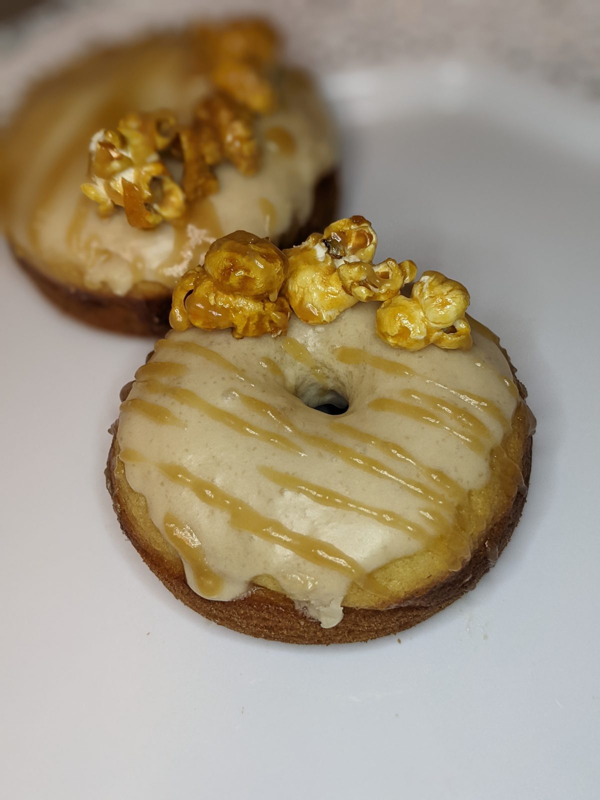 Glazed donuts topped with caramel popcorn
