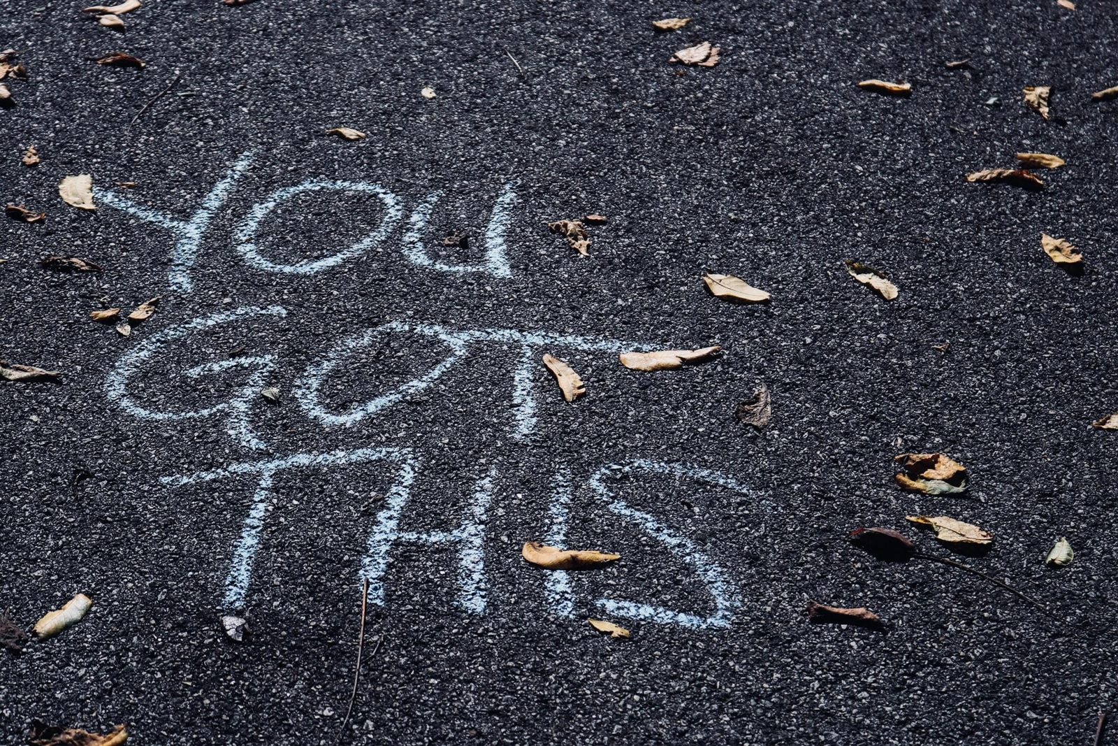 Sidewalk chalk message reading you got this